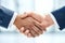 Another successful corporate merger. Closeup shot of two businesspeople shaking hands together in an office.