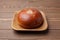 anpan round bread with azuki red beans paste isolated on plate on wooden table