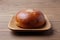 anpan round bread with azuki red beans paste isolated on plate on wooden table