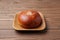 anpan round bread with azuki red beans paste isolated on plate on wooden table