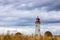 Anse a la Cabane lighthouse on the Magdalen Islands, low level through wheat field