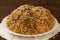 ant hill cake decorated with poppy seeds on a white plate. the concept of a festive tea party