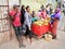 Antananarivo, Madagascar - April 24, 2019: Group of unknown Malagasy people standing near woman selling bananas on the street.