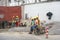 Antananarivo, Madagascar - April 24, 2019: Group of unknown Malagasy worker men in helmets and hi visibility jackets, resting at