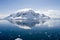 Antarctic ice-covered mountain reflected in water