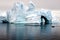 Antarctic iceberg with zodiac in front, iceberg sculptured like fairytale castle