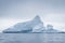 Antarctic icebergs and majestic landscape, cloudy blue sky