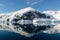 Antarctic seascape with icebergs and reflection