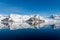 Antarctic seascape with icebergs and reflection