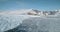 Antarctica glacier ocean shore landscape aerial. Melting snow covered glacier at winter sun day.