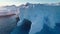 Antarctica huge iceberg with caves in sunset