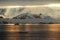 Antarctica landscape, icebergs, mountains and ocean at sunrise