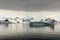 Antarctica landscape, icebergs, mountains and ocean at sunrise