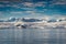 Antarctica mountains and sea. Clouds and blue sky