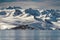 Antarctica mountains and sea. Clouds and blue sky