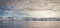 Antarctica mountains and sea. Clouds and blue sky