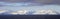 Antarctica Snow Capped Mountains, four photo stitch Panoramic. Storm clouds and blue sky.