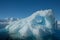 Antarctica unique blue iceberg art texture beneath clear sky. snowy mountains
