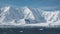 Antarkeic landscape with snowy mountains, glaciers and icebergs. Landscape of icy shores in Antarctica. Beautiful blue