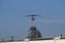 Antenna at the airport, radar system near the airport, against a blue clear sky with a small cloud. Airport and aircraft