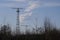 Antenna at the airport, radar system near the airport, against a blue clear sky with a small cloud. Airport and aircraft