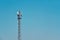 Antenna mast on blue background with copy free space