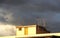 Antennas on a roof, against a cloudy sky