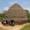 an anthill for people, a large house made of natural materials and many people in it, unusual architecture,