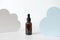 Anti-aging collagen hyaluronic acid facial serum in brown glass bottle with dropper and cloud shape decor on white background