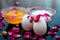 Anti-aging face pack i.e.  Milk and egg face pack in a glass bowl on shiny black surface with some rose petals