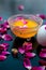 Anti-aging face pack i.e.  Milk and egg face pack in a glass bowl on shiny black surface with some rose petals