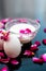 Anti-aging face pack i.e.  Milk and egg face pack in a glass bowl on shiny black surface with some rose petals