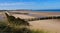 Anti-erosion wooden piles to retain sand on Wissant beach on the edge of the English Channel on the Opal Coast in France