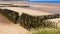 Anti-erosion wooden piles to retain sand on Wissant beach on the edge of the English Channel on the Opal Coast in France