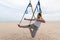 Anti-gravity Yoga, man doing yoga exercises or fly-yoga on the sea background