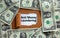 Anti Money Laundering concept. The text `Anti Money Laundering` appearing behind torn brown paper. Dollar bills