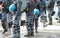 Anti-riot police cops with protective helmet during patrolling t