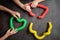 Anti stress sensory pop tube toys in a children`s hands. a little happy kids plays with a poptube toy on a black table. toddlers