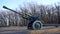 Anti tank gun in military park. Old anti tank cannon monument mounted on pedestal on winter day in military park