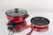 Antiaderente red electric skillet and pans; photo on white background