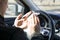 antibacterial treatment of a taxi car, a young male driver wipes his hands, with an antibacterial cloth.