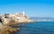 Antibes city with Alps in the background and a commercial Aircraft approaching airport on a sunny day