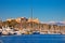 Antibes harbor and old fortress with Alps snow peaks background view