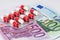 Antibiotic capsules in blister with euro banknotes