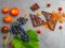anticancer food, good for cardiovasculas system, fresh ripe grape, dark chocolate, raspberries, tomatoes, apple on concrete