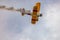 Antidotum Airshow Leszno 2023 and acrobatic shows of yellow Boeing Stearman plane on a blue clouy