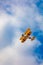 Antidotum Airshow Leszno 2023 and acrobatic shows of yellow Boeing Stearman plane on a blue clouy