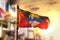 Antigua and Barbuda Flag Against City Blurred Background At Sunrise Backlight