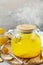Antioxidant ginger turmeric lemon tea with honey on a stone table. Healthy organic vegan drink. Winter tea, Immunity boosting