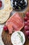Antipasti appetizer with grapes, olives, cheese and meat